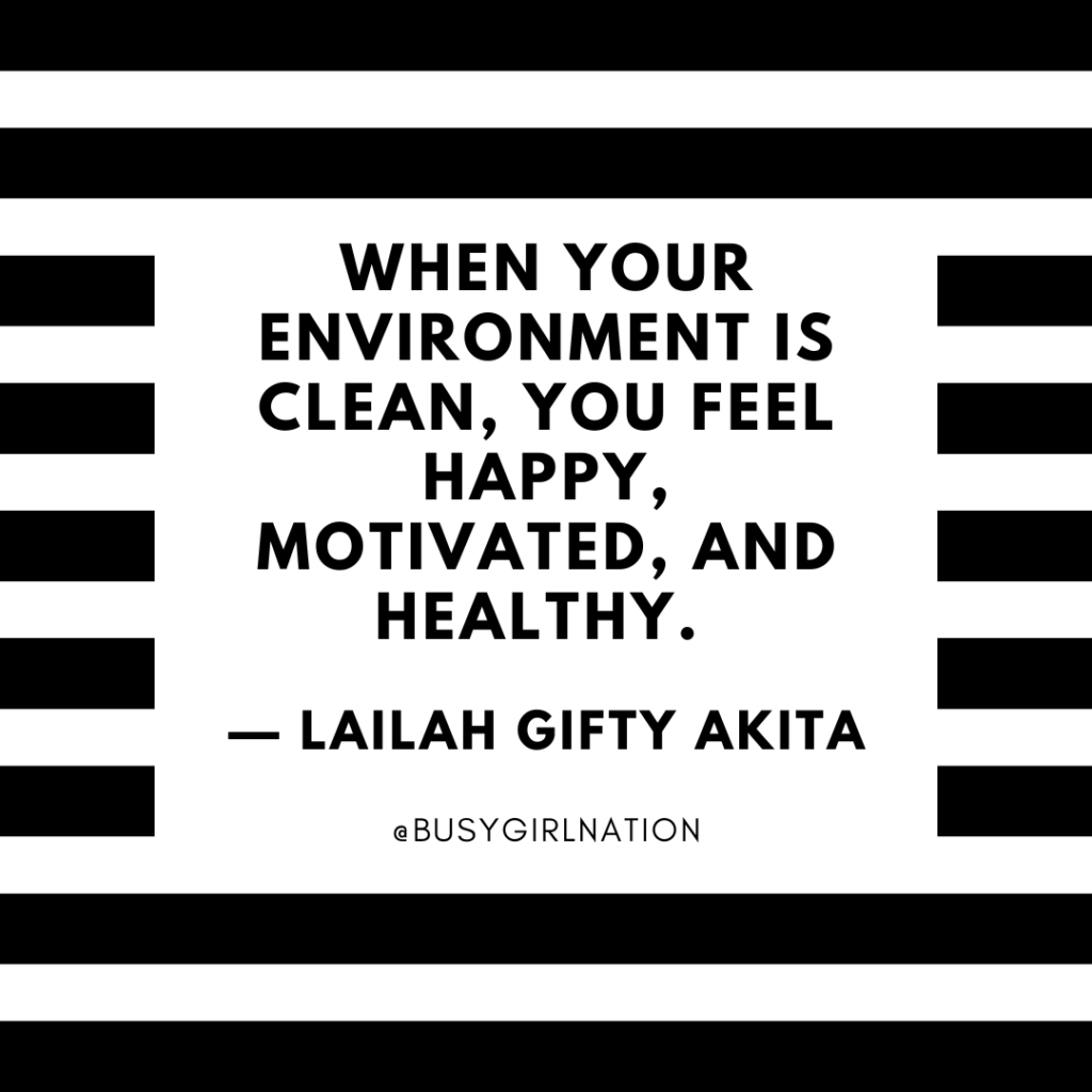 Text graphic with bold black and white horizontal stripes. Central quote reads, When your environment is clean, you feel happy, motivated, and healthy. — Lailah Gifty Akita. At the bottom is the handle @BUSYGIRLNATION.