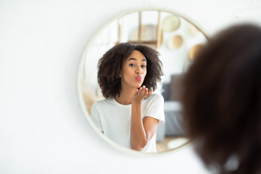 girl blowing kiss in mirror