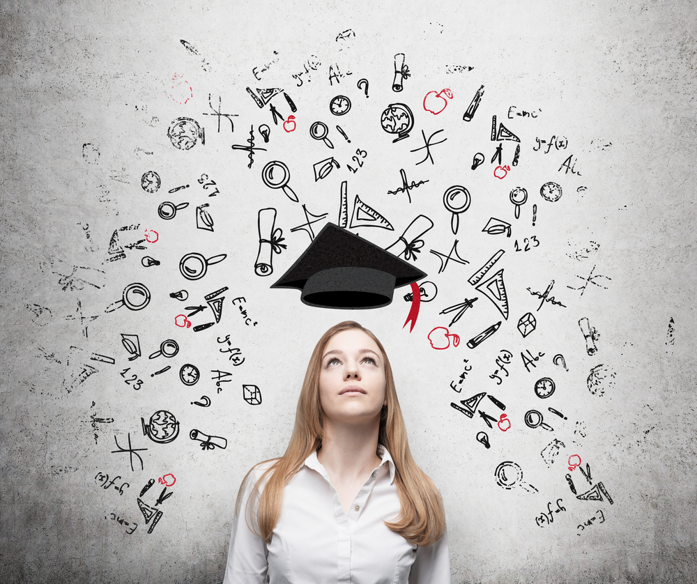 A woman in a white shirt looks up at a floating graduation cap. Around her, doodles of mathematical symbols and equations symbolize education and learning, illuminating the path to high-paying careers that many women aspire to, as predicted by BLS Data trends.